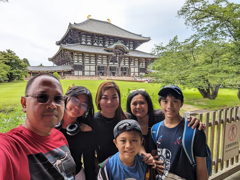 Family selfie in front of Todai-ji Temple's Great Buddha Hall in Nara, Japan.