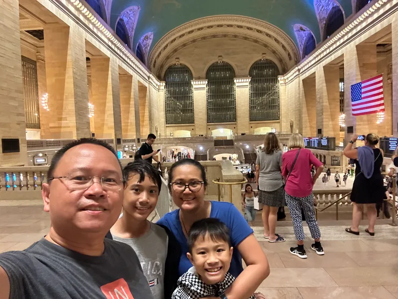 Family selfie inside Grand Central Terminal with grand architecture