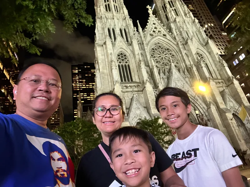 Family selfie at night in front of St. Patrick's Cathedral
