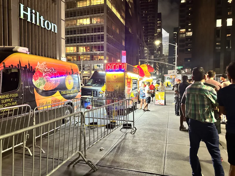 NYC street food trucks at night including Halal Guys