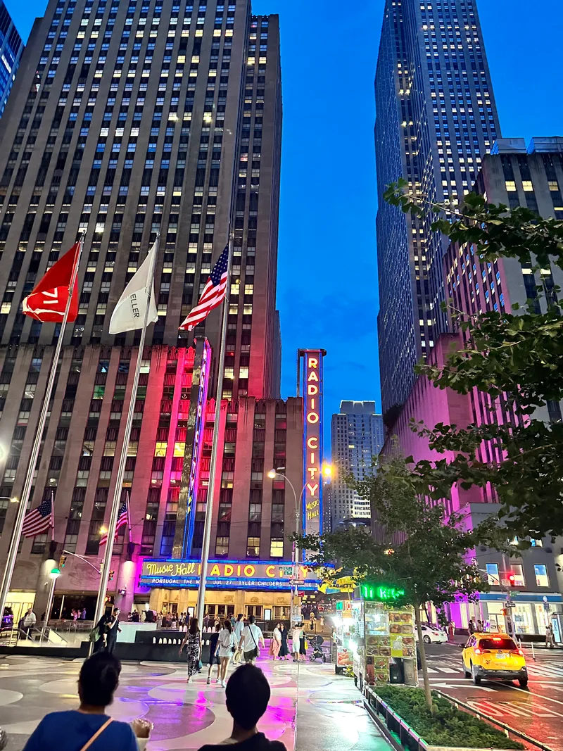 Radio City Music Hall exterior at dusk with neon lights