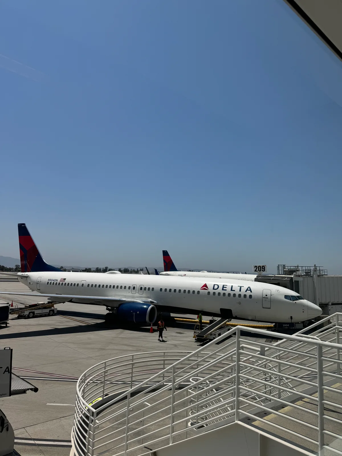 Delta Boeing 737 at Ontario International Airport gate under clear blue sky, ready for Chicago flight